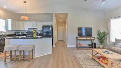 a kitchen and living room with a counter and a table at Elsie's Cove - Close to the Beach in Seagrove along 30A in Santa Rosa Beach