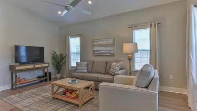 a living room with a couch and a tv at Elsie's Cove - Close to the Beach in Seagrove along 30A in Santa Rosa Beach