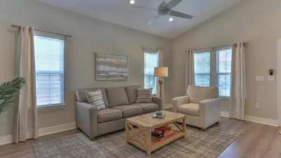 a living room with a couch and chairs and windows at Elsie's Cove - Close to the Beach in Seagrove along 30A in Santa Rosa Beach