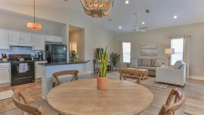 a kitchen and living room with a table and chairs at Elsie's Cove - Close to the Beach in Seagrove along 30A in Santa Rosa Beach