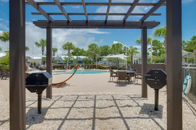 a view of the pool at a resort with a playground at Elsie's Cove - Close to the Beach in Seagrove along 30A in Santa Rosa Beach