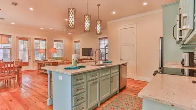 a kitchen with a large island and a living room at Family Ties - Located in Seacrest Beach 2 Master bedrooms and a large communal pool in Rosemary Beach