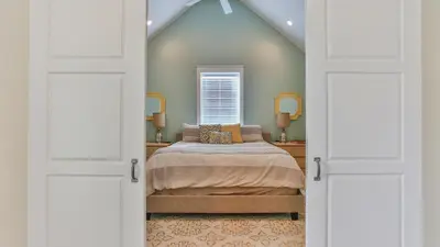 a bedroom with a bed and a window at Family Ties - Located in Seacrest Beach 2 Master bedrooms and a large communal pool in Rosemary Beach