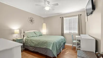 a bedroom with a bed and a ceiling fan at Great Vibes in Panama City Beach