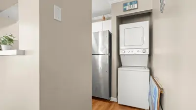 a kitchen with a refrigerator and a microwave at Great Vibes in Panama City Beach