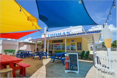 a restaurant with tables and umbrellas in front of it at Great Vibes in Panama City Beach