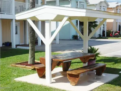 a picnic table and bench in a park at Great Vibes in Panama City Beach