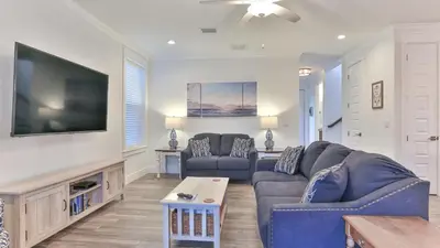 a living room with two couches and a flat screen tv at Hook, Wine, and Sinker - 3 plus Bedrooms Gulf views on 30A sleeps 12 with a hot tub in Santa Rosa Beach