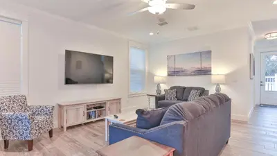 a living room with a couch and a tv at Hook, Wine, and Sinker - 3 plus Bedrooms Gulf views on 30A sleeps 12 with a hot tub in Santa Rosa Beach