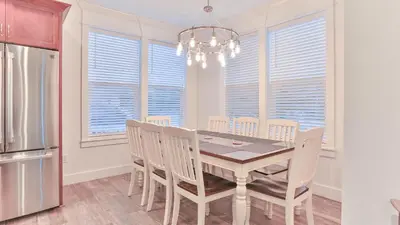 a dining room with a table and chairs and a refrigerator at Hook, Wine, and Sinker - 3 plus Bedrooms Gulf views on 30A sleeps 12 with a hot tub in Santa Rosa Beach
