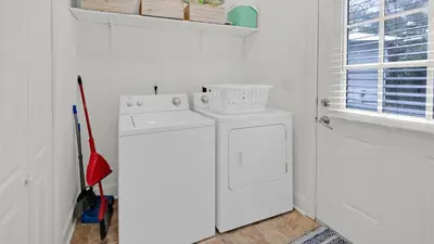 a white laundry room with a washing machine and a window at Once Upon a Tide - Close to Seaside on 30A and 3 blocks to beach in Santa Rosa Beach