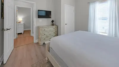 a bedroom with a bed and a dresser and a television at Once Upon a Tide - Close to Seaside on 30A and 3 blocks to beach in Santa Rosa Beach