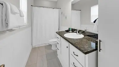 a white bathroom with a sink and a toilet at Once Upon a Tide - Close to Seaside on 30A and 3 blocks to beach in Santa Rosa Beach