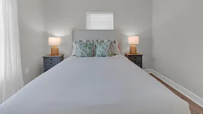 a bedroom with a large white bed with two lamps at Once Upon a Tide - Close to Seaside on 30A and 3 blocks to beach in Santa Rosa Beach