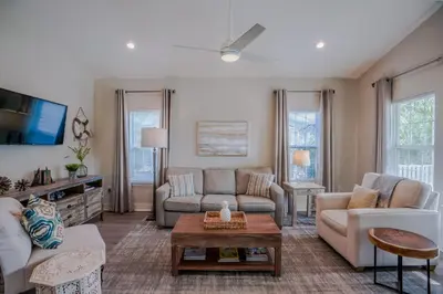a living room with a couch and a table at Ocean Antics - Close to the Beach and minutes to Seaside along 30A in Santa Rosa Beach