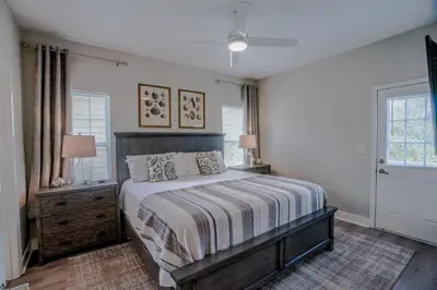 a bedroom with a bed and two windows at Ocean Antics - Close to the Beach and minutes to Seaside along 30A in Santa Rosa Beach
