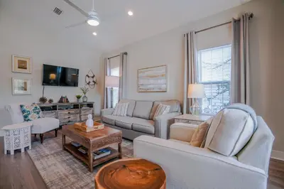 a living room with two couches and a tv at Ocean Antics - Close to the Beach and minutes to Seaside along 30A in Santa Rosa Beach