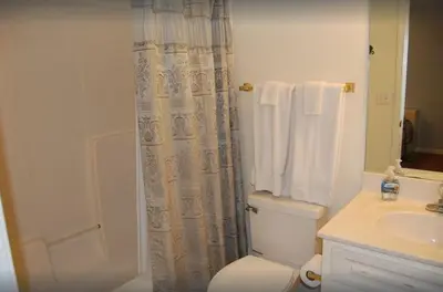 a bathroom with a toilet and a sink and a shower at Dolphin house with Private Pool and Near Beach in Panama City Beach