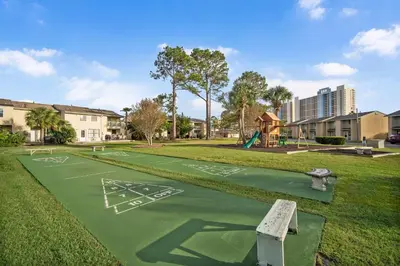 a playground in a park with a playing field at Gulf Highlands #106 in Panama City Beach