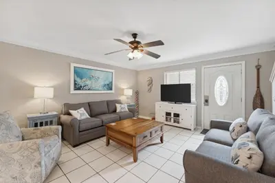 a living room with a couch and a tv at Gulf Highlands #106 in Panama City Beach