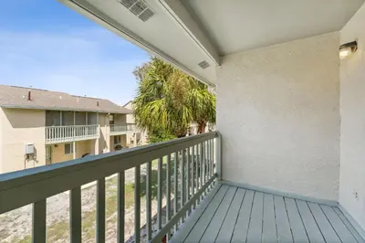 a balcony with a view of a building at Gulf Highlands #106 in Panama City Beach