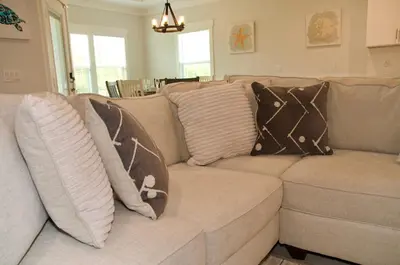 a couch with pillows on it in a living room at Peaceful Shores Retreat in Panama City Beach