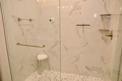 a bathroom with a shower with a glass door at Peaceful Shores Retreat in Panama City Beach