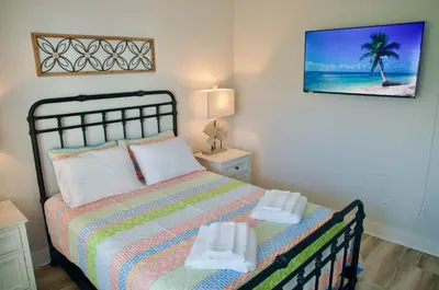 a bedroom with a bed with two towels on it at Peaceful Shores Retreat in Panama City Beach