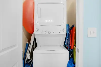 a white washer and dryer in a closet at Sterling Reef 603 in Panama City Beach
