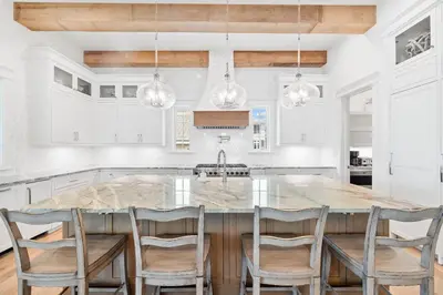 a kitchen with a large island with chairs around it at Summer Villa - 274 Pompano Street home in Inlet Beach