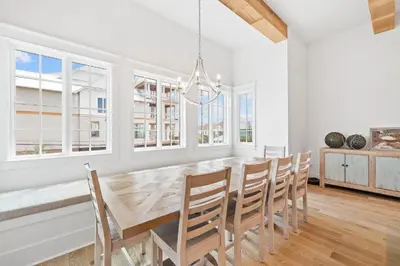 a dining room with a large wooden table and chairs at Summer Villa - 274 Pompano Street home in Inlet Beach