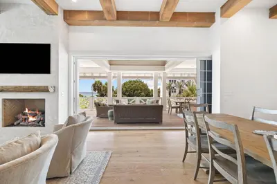 a living room with a table and chairs and a fireplace at Summer Villa - 274 Pompano Street home in Inlet Beach