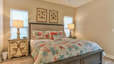 a bedroom with a bed and two night stands with lamps at After Dune Delight - 3 blocks to the beach less than a mile to Seaside! in Santa Rosa Beach