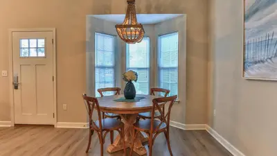a dining room with a table and chairs and a chandelier at After Dune Delight - 3 blocks to the beach less than a mile to Seaside! in Santa Rosa Beach