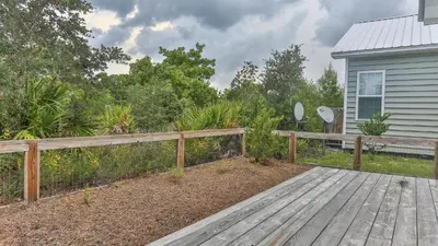 a wooden deck in front of a house at After Dune Delight - 3 blocks to the beach less than a mile to Seaside! in Santa Rosa Beach