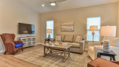 a living room with a couch and a table at After Dune Delight - 3 blocks to the beach less than a mile to Seaside! in Santa Rosa Beach