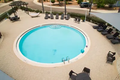 an overhead view of a large swimming pool with chairs at After Dune Delight - 3 blocks to the beach less than a mile to Seaside! in Santa Rosa Beach