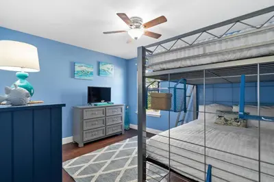 a bedroom with blue walls and a bunk bed at 30A Pet Friendly Beach House - Pelican's Rest by Panhandle Getaways in Rosemary Beach