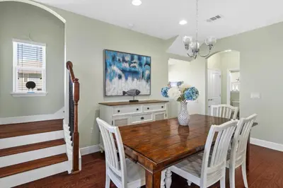 a dining room with a wooden table and white chairs at 30A Pet Friendly Beach House - Pelican's Rest by Panhandle Getaways in Rosemary Beach