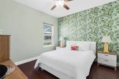 a bedroom with a white bed and a green wall at 30A Pet Friendly Beach House - Pelican's Rest by Panhandle Getaways in Rosemary Beach