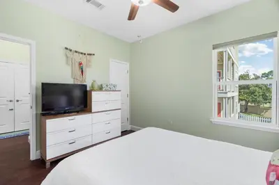 a bedroom with a bed and a tv and a window at 30A Pet Friendly Beach House - Pelican's Rest by Panhandle Getaways in Rosemary Beach