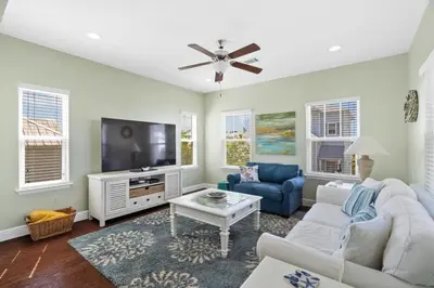 a living room with a white couch and a tv at 30A Pet Friendly Beach House - Pelican's Rest by Panhandle Getaways in Rosemary Beach