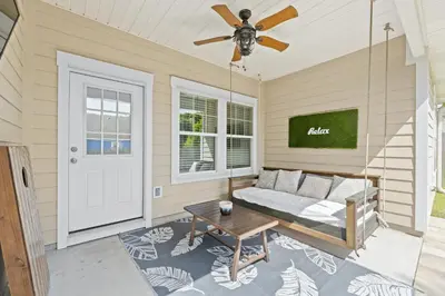 a living room with a couch and a ceiling fan at Pet Friendly Beach House - The Beach Getaway by Panhandle Getaways in Panama City Beach