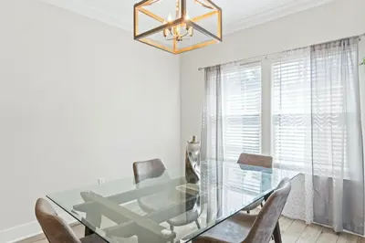 a dining room with a glass table and chairs at Pet Friendly Beach House - The Beach Getaway by Panhandle Getaways in Panama City Beach