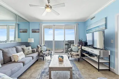 a living room with a couch and a piano at Twin Palms Beach Resort by Panhandle Getaways in Panama City Beach