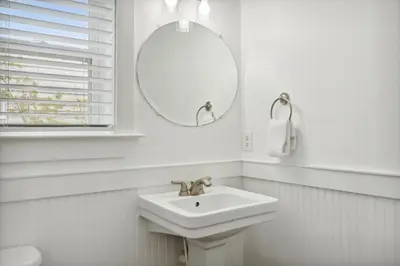 a white bathroom with a sink and a mirror at 30A Beach House - Beach Bikin by Panhandle Getaways in Panama City Beach