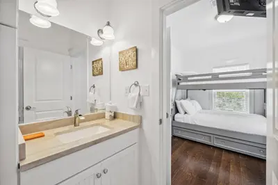 a bathroom with a sink and a bed at 30A Beach House - Beach Bikin by Panhandle Getaways in Panama City Beach