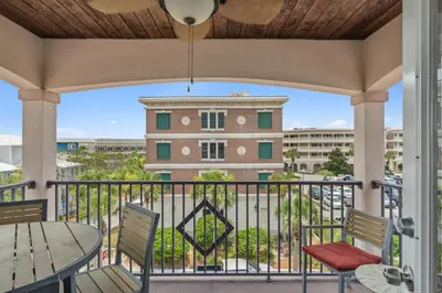 a balcony with a table and chairs and a building at 30A Beach House - Beach Bikin by Panhandle Getaways in Panama City Beach
