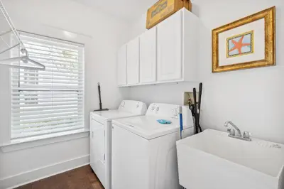 a white laundry room with a washing machine and a sink at 30A Beach House - Beach Bikin by Panhandle Getaways in Panama City Beach
