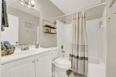 a white bathroom with a toilet and a sink at Two Spaces in One Main House and Guest House 25 Min to PCB in Panama City